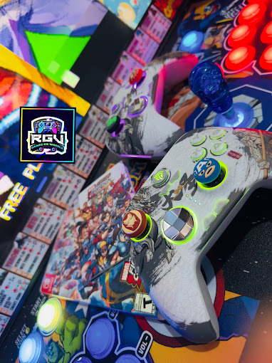 Close-up of a lit arcade control panel and wireless controller inside the RGV Games on Wheelz bus