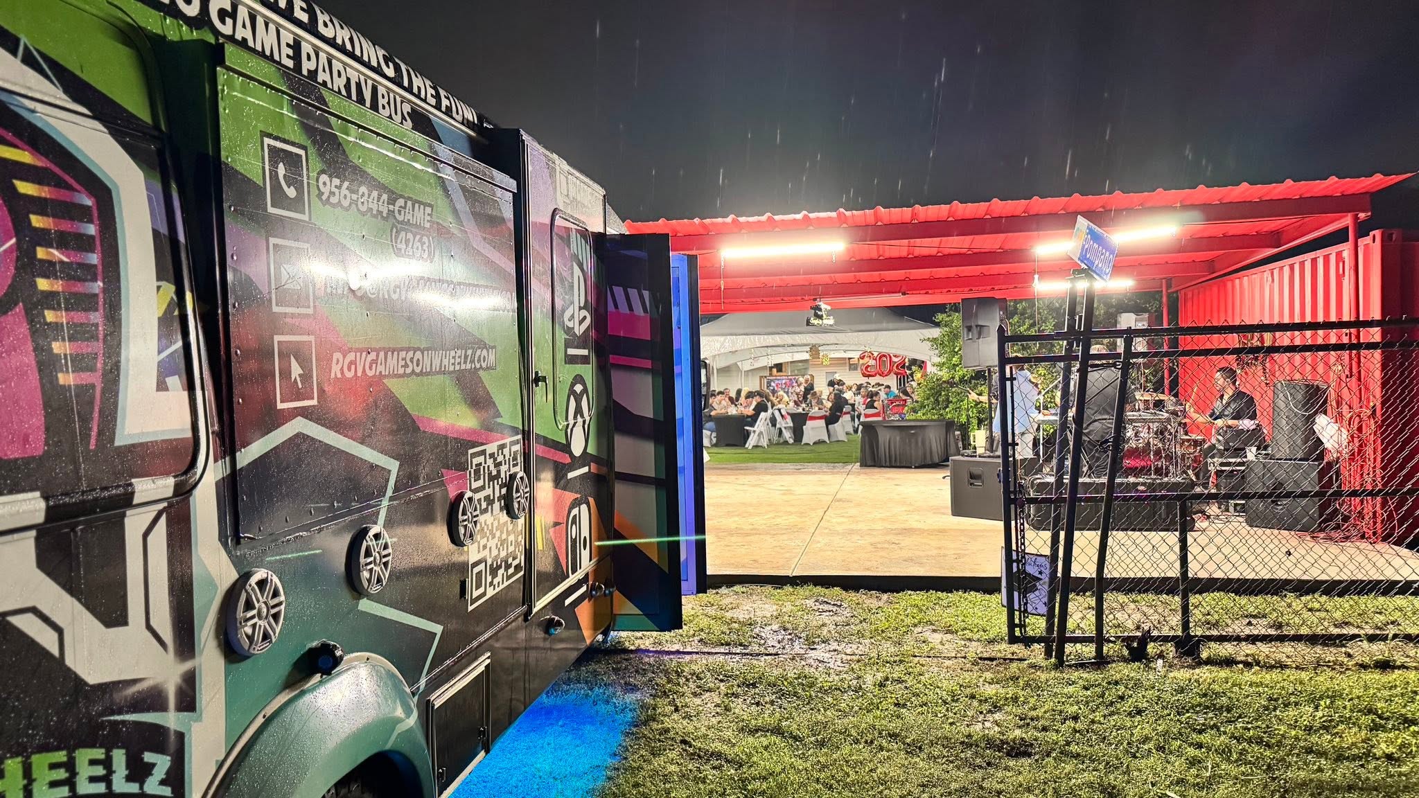 The gaming bus set up with its door open at a covered evening event in the Rio Grande Valley